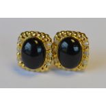 A pair of Modernistic 18ct onyx and diamond ear studs. Est. £300 - £350.