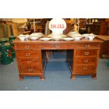 A large French twin pedestal desk with string inlay and cross banded decoration. Est. £600 - £650.