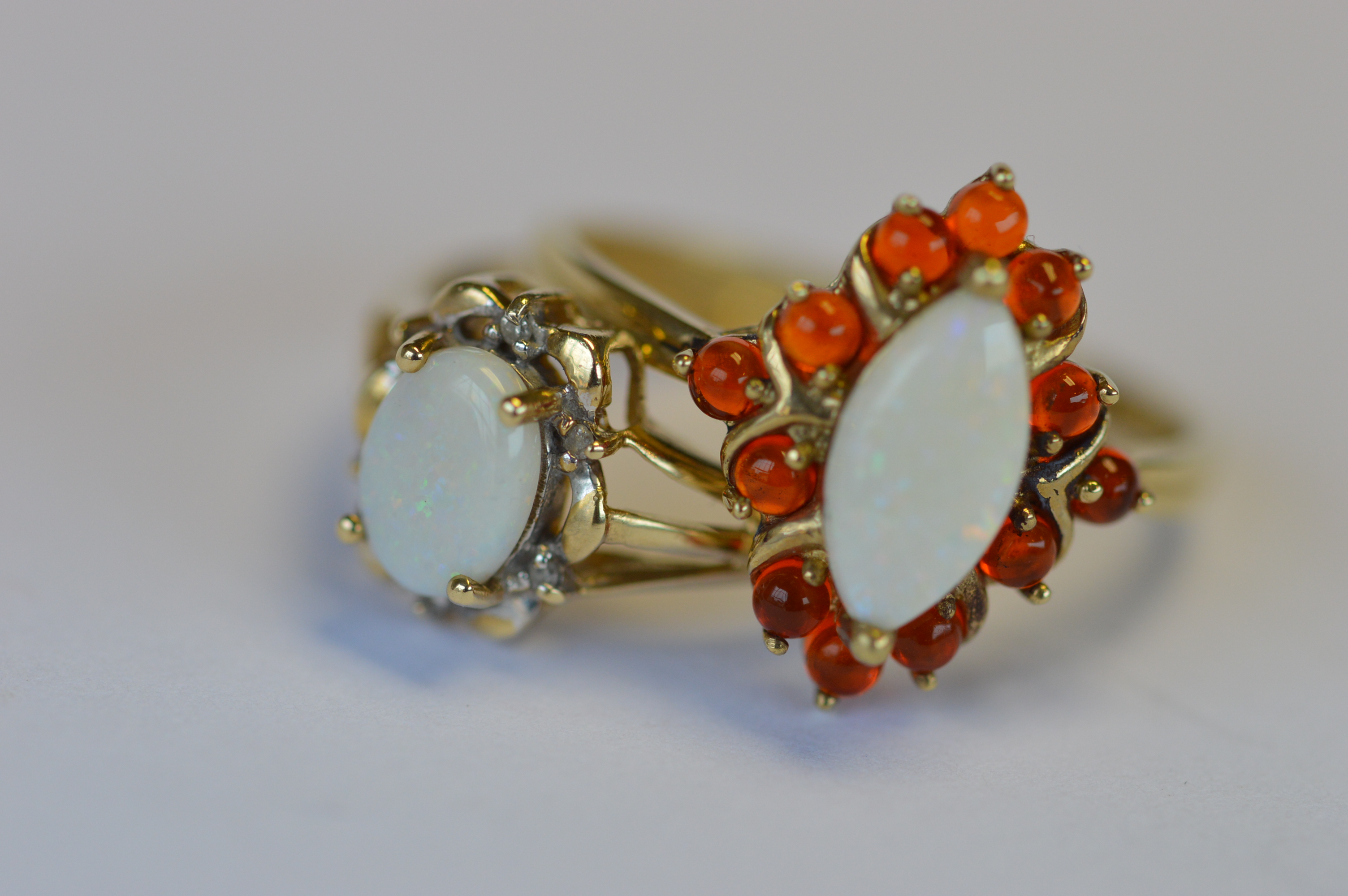 Two 9ct opal decorated cluster rings. Approx 5.1 grams. Est. £80 - £90.