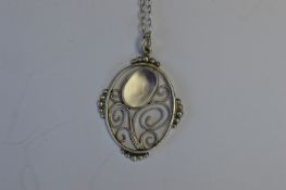 A silver Arts and Crafts pendant on fine link chain with loop top. Est. £60 - £70.