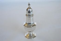 A large nine inch octagonal sugar castor. Birmingham 1931 by SB. Est. £150 - £180.