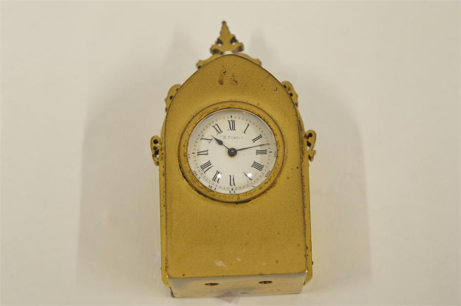 A miniature bedside clock in brass of Gothic design. By Benson. Est. £50 - £60.