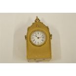 A miniature bedside clock in brass of Gothic design. By Benson. Est. £50 - £60.