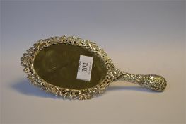 An attractive oval embossed hand mirror decorated with trees, birds and flowers. Birmingham. By SWS.