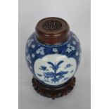 An 18th Century Chinese blue and white ginger jar and cover on stand. Est. £300 - £400.