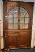 A large impressive corner cabinet with reeded stems, and oval doors. Est. £500 - £600.