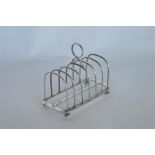 A good Gothic arched bar toast rack on four cast bun feet. By G & S. Est. £200 - £250.