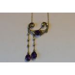 An attractive amethyst and diamond drop pendant with two matching drops mounted as knife edge