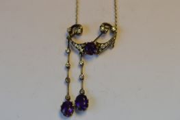 An attractive amethyst and diamond drop pendant with two matching drops mounted as knife edge