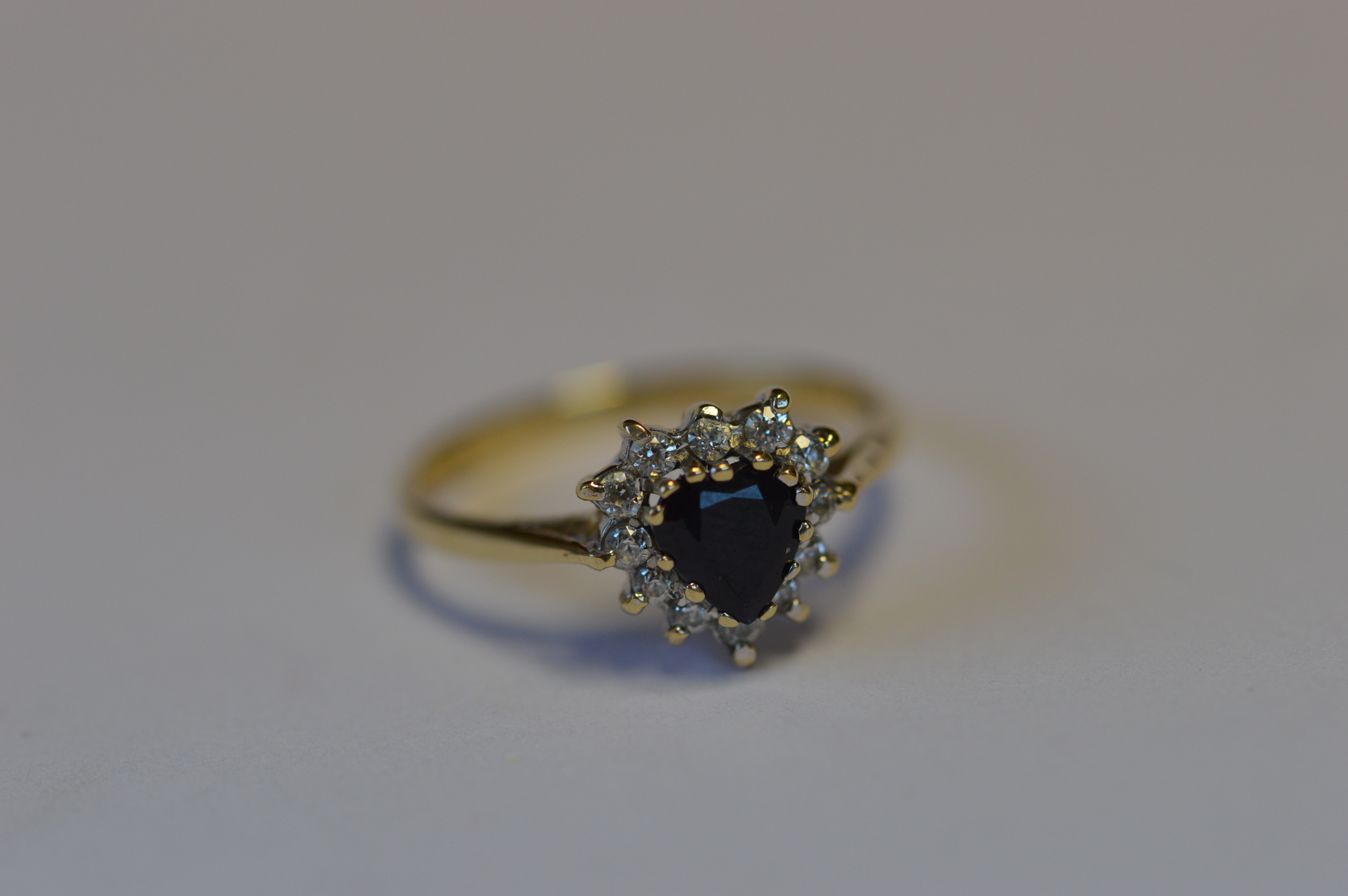 A 9ct sapphire and CZ cluster ring. Est. £60 - £70.