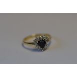 A 9ct sapphire and CZ cluster ring. Est. £60 - £70.