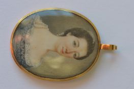 A good oval Georgian gold miniature of a lady with low crop top in gold reeded frame. Est. £600 - £