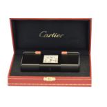 A boxed Cartier travel clock with pull out sides, compete with original paperwork. Est. £150 - £