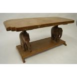 A good hardwood occasional table mounted on elephant pedestals. Est. £100 - £120.
