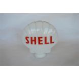 A good irridescent glass Shell petrol pump globe. (Slight chipping to base.) Est. £200 - £250.