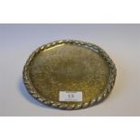 An attractive Victorian salver decorated with scrolls and central stag armorial with rope twist