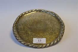 An attractive Victorian salver decorated with scrolls and central stag armorial with rope twist