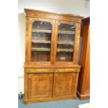 A good quality Victorian walnut inlaid flat front bookcase decorated with scrolls and flowers with