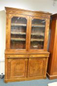 A good quality Victorian walnut inlaid flat front bookcase decorated with scrolls and flowers with