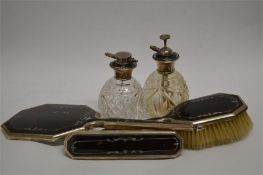 An attractive tortoiseshell mirror, brush and bottle set with silver inlay. Est. £120 - £140.