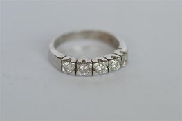 A heavy 18ct five stone half hoop ring in white gold. Est. £120 - £150.