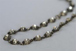 An attractive silver and paste riviere necklace with ring clasp. Est. £120 - £140.