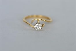 A single stone diamond twist ring in claw mount. Est. £160 - £180.