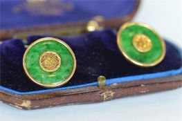 A pair of attractive boxed gold and jade cufflinks. Est. £400 - £450.