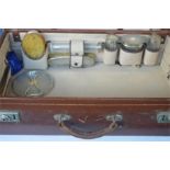 A good cased seven piece travelling dressing table set in leather suitcase. Est. £40 - £50.