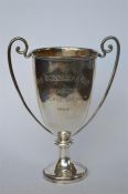 A small two handled trophy cup on tapered base. London 1908. By M&W. Approx. 260 grams. Est. £