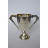 An Art Deco style two handled trophy cup with tapered body. Birmingham 1931. By AEP. Approx. 300