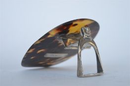 An attractive unusual tortoiseshell mounted desk clip in the form of a stirrup with buckle top.