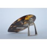 An attractive unusual tortoiseshell mounted desk clip in the form of a stirrup with buckle top.