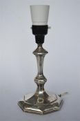 A silver candlestick with tapered stem. Sheffield 1926. By HE. Est. £30 - £40.