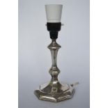 A silver candlestick with tapered stem. Sheffield 1926. By HE. Est. £30 - £40.