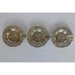 A group of three embossed ashtrays decorated with swirls and leaves. Approx. 55 grams. Est. £20 - £