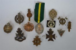 A box containing Paddington's rifle badge together with a South Africa wreath badge and numerous