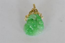 An attractive green jade pendant on loop top, mounted with diamonds. Est. £700 - £800.