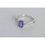 An attractive modern diamond and tanzanite ring in white gold crossover setting. Est. £380 - £420.