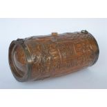 A cylindrical Chinese biscuit barrel carved with wooden scenes and brass mounts. Est. £25 - £30.