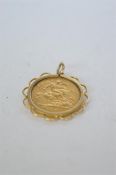 A 1898 Victorian half sovereign in gold surround. Est. £90 - £100.