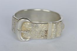 An attractive engraved buckle bangle with concealed clasp. Est. £120 - £140.