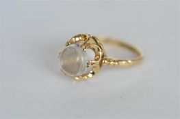 A small moonstone ring in claw mount. Est. £30 - £40.