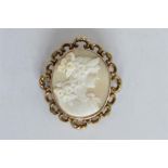 An attractive oval cameo of a lady's head with scroll decorated frame. Est. £50 - £60.