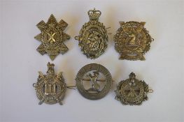 A Scottish Kings Borders badge together with The Black Watch badge and others. Est. £40 - £50.