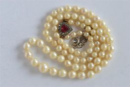 An attractive single string of pearl beads with heart shaped paste clasp. Est. £40 - £50.