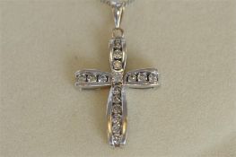 A good quality white gold diamond cross on fine link chain with loop top. Est. £250 - £300.