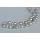 A long string of pearl beads. Est. £30 - £40.