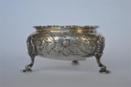 An attractive Victorian single salt decorated with flowers and leaves on hoof feet with gilt