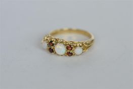 A heavy 9ct garnet and opal seven stone ring. Est. £40 - £50.
